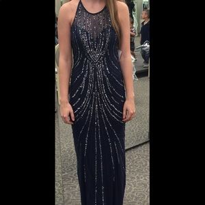 Sleeveless, backless long navy dress with beading